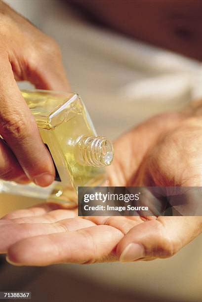 applying aftershave - aftershave bottle stock pictures, royalty-free photos & images