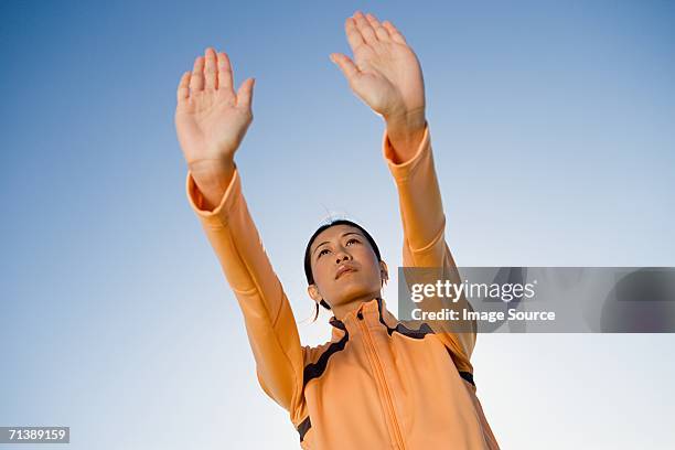 woman with arms outstretched - woman and tai chi stock pictures, royalty-free photos & images