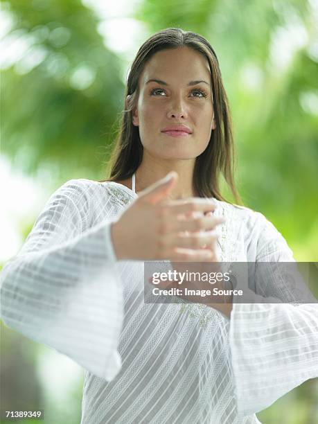 woman doing tai chi - woman and tai chi stock pictures, royalty-free photos & images