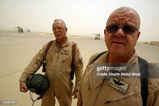 Army pilots CW5 DeWayne Browning and CW3 Randy Weatherhead veterans of the Vietnam war pose for photographys in the base airfield on June 12, 2005 in...