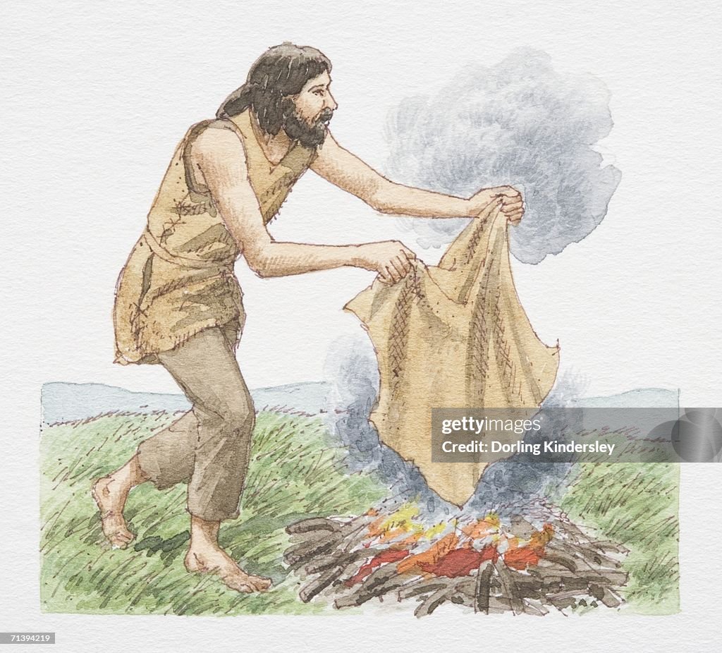 Man holding blanket over open fire to create smoke signals, side view.