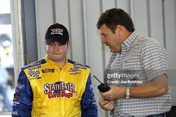 Bobby East, driver of the State Fair Corn Dogs/Edy's Dibs Ford, talks with former series driver Robert Pressley during the NASCAR Craftsman Truck...