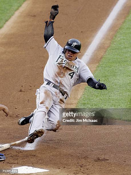 Alfredo Amezaga of the Florida Marlins scores on a throwing error in the 1st inning against the New York Mets on July 7, 2006 at Shea Stadium in the...