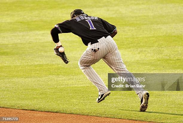 Second baseman Orlando Hudson of the Arizona Diamondbacks loses control of a ground ball hit by Jamey Carroll of the Colorado Rockies in the first...