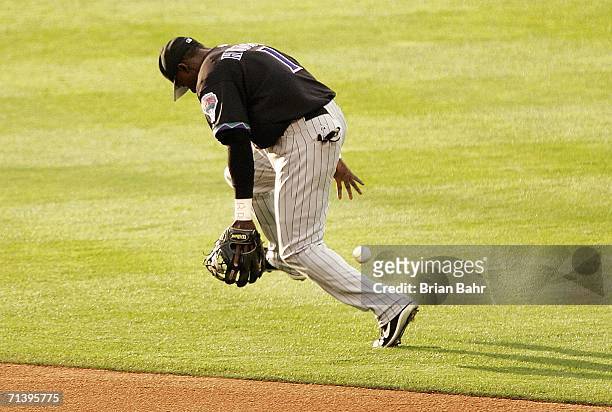 Second baseman Orlando Hudson of the Arizona Diamondbacks loses control of a ground ball hit by Jamey Carroll of the Colorado Rockies in the first...