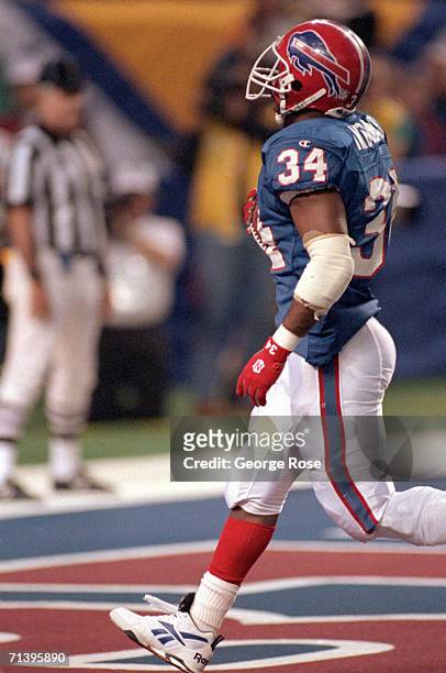 Running back Thurman Thomas of the Buffalo Bills runs for a four yard touchdown against the Dallas Cowboys during Super Bowl XXVIII at the Georgia...