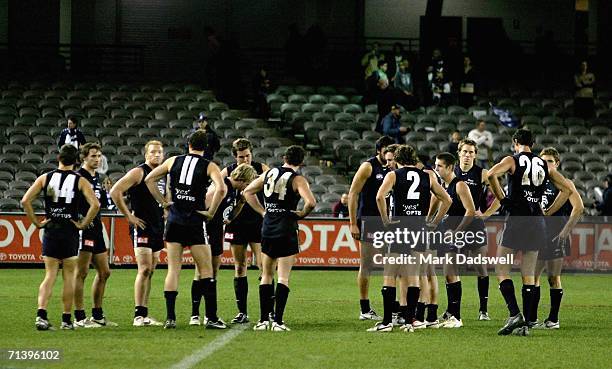 Carlton players gather together looking dejected after losing the round 14 AFL match between the Carlton Blues and Geelong Cats at Telstra Dome July...