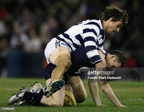 Matthew McCarthy of the Cats tackles Heath Scotland of the Blues during the round 14 AFL match between the Carlton Blues and Geelong Cats at Telstra...