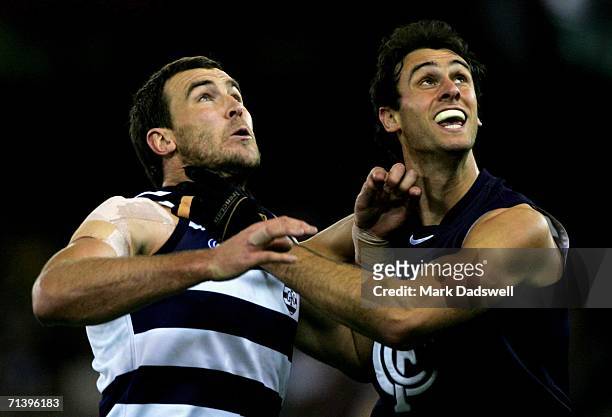 Steven King of the Cats contests a boundary throw in with Adrian Deluca of the Blues during the round 14 AFL match between the Carlton Blues and...