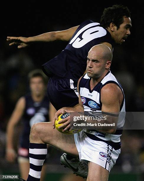 Paul Chapman of the Cats marks despite the efforts of Eddie Betts of the Blues during the round 14 AFL match between the Carlton Blues and Geelong...