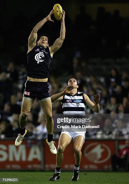 Brendan Fevola of the Blues marks in front of Matthew Scarlett of the Cats during the round 14 AFL match between the Carlton Blues and Geelong Cats...