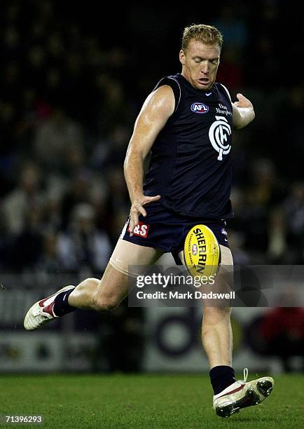 Lance Whitnall of the Blues kicks to a teammate during the round 14 AFL match between the Carlton Blues and Geelong Cats at Telstra Dome July 8, 2006...