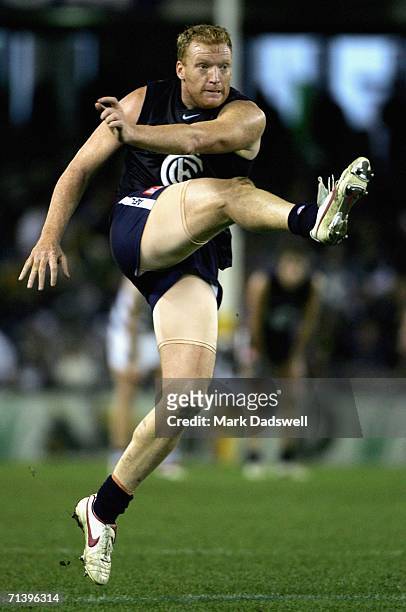 Lance Whitnall of the Blues kicks for goal during the round 14 AFL match between the Carlton Blues and Geelong Cats at Telstra Dome July 8, 2006 in...