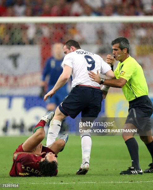 Gelsenkirchen, GERMANY: This file photo dated 01 July 2006 shows Argentinian referee Horacio Elizendo whistling as English forward Wayne Rooney...