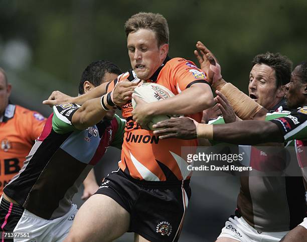 Peter Lupton of Castleford is stopped by the Harlequin defence during the Super League XI match between Harlequins RL and Castleford Tigers on July...