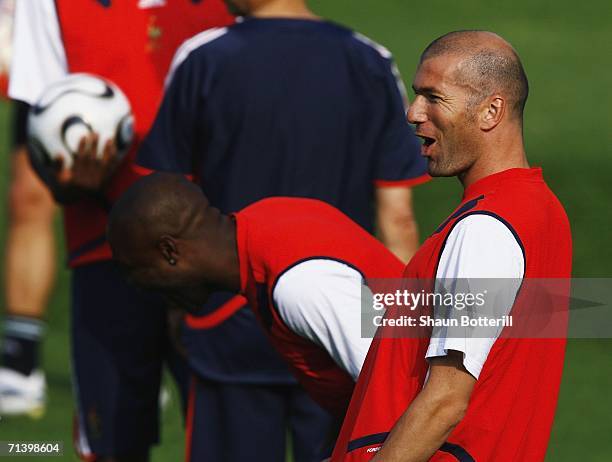 Zinedine Zidane of France shares a joke with team-mates during French training at Wurfplatz Stadium on July 8, 2006 in Berlin, Germany. France plays...