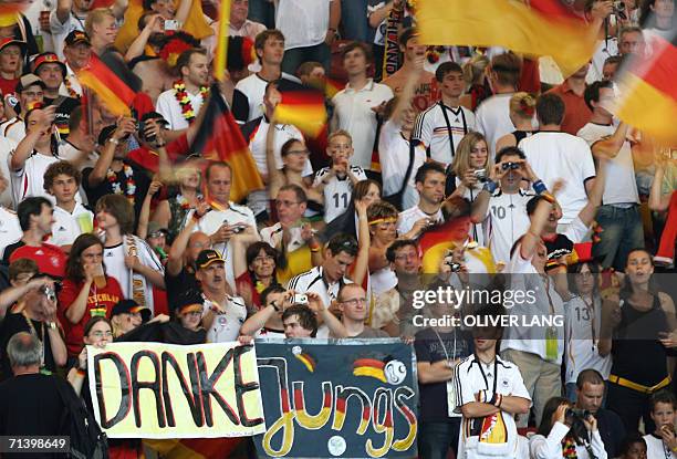 Germany supporters cheer and wave flags before the start of the third-place playoff 2006 World Cup football match between Germany and Portugal at...