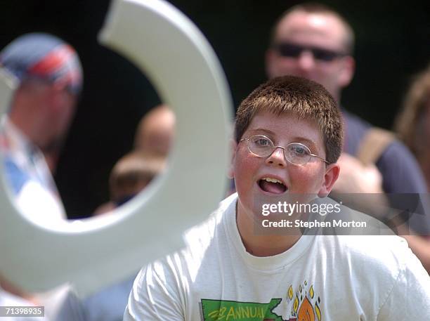 Contestant Shane Wright of Eastman, Georgia throws a plastic toilet seat during the Redneck Horseshoes contest July 8, 2006 in Dublin, Georgia....