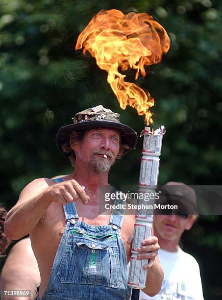 Bow, the official mascot of the Summer Redneck Games, lights the ceremonial torch to kick-off the 11th annual Summer Redneck Games July 8, 2006 in...