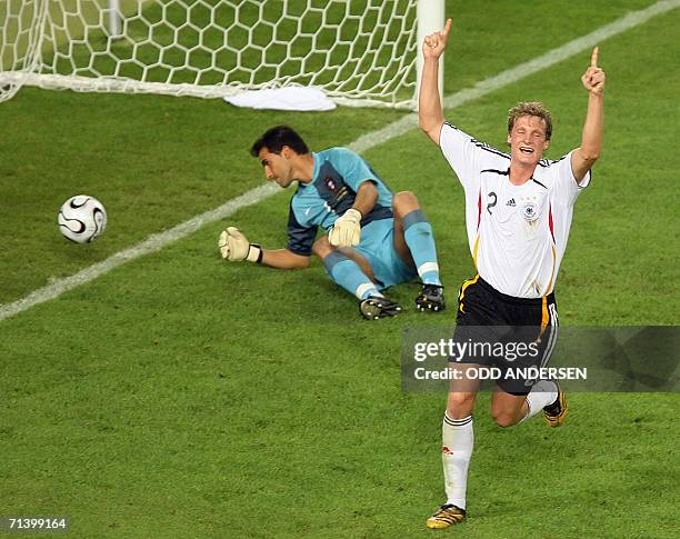 German defender Marcell Jansen celebrates next to Portuguese goalkeeper Ricardo after Portuguese midfielder Petit scored an own goal during the World...