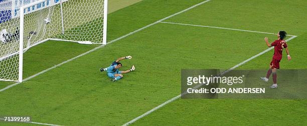 Portuguese Fernando Meira looks on as Portuguese goalkeeper Ricardo fails to stop a goal by German midfielder Bastian Schweinsteiger during the...