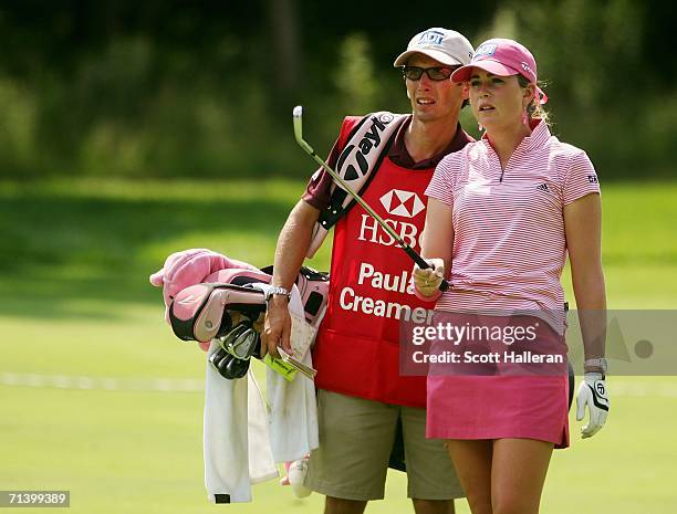 Paula Creamer and her caddy Colin Cann talk on the 15th fairway during the Quarterfinals of the HSBC Women's World Match Play Championship on July 8,...