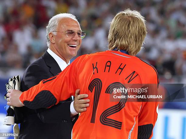 German goalkeeper Oliver Kahn is congratulated by German football legend and president of the World Cup organising committee Franz Beckenbauer...