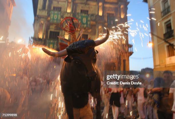 Toro del Fuego, flaming bull, is run through the streets of Pamplona during the San Fermin fiesta on July 8, 2006 in Pamplona, Spain. The running of...