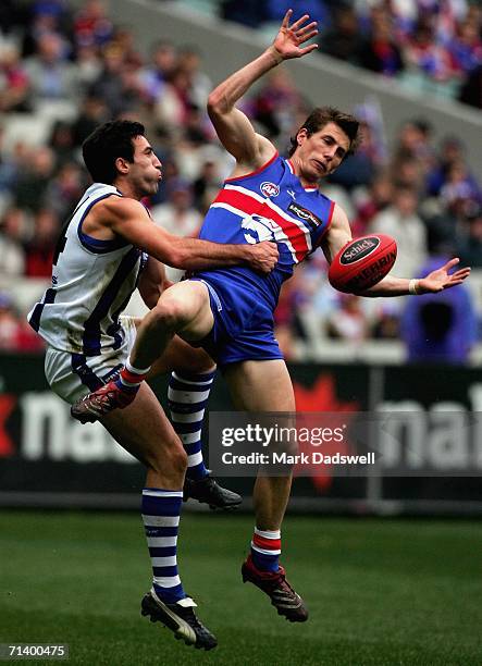 Matthew Boyd of the Bulldogs attempts to mark over Michael Firrito of the Kangaroos during the round 14 AFL match between the Western Bulldogs and...