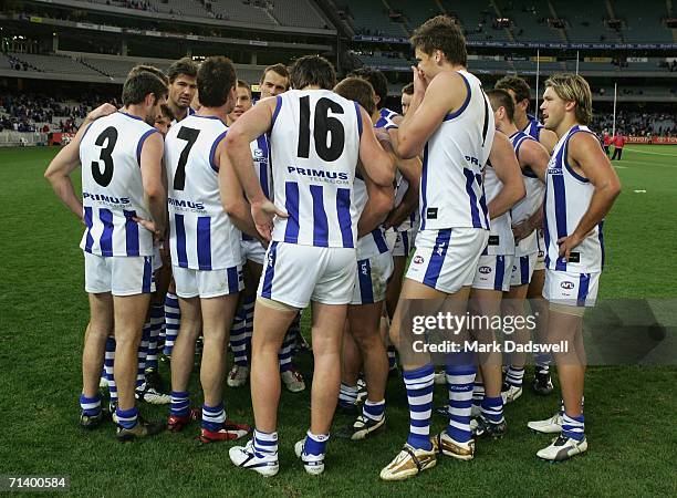 Adam Simpson Captain of the Kangaroos calls his team together after winning the round fourteen AFL match between the Western Bulldogs and the...