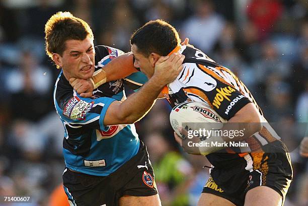 Reece Williams of the Sharks tackles Ben Galea of the Tigers during the round 18 NRL match between the Cronulla Sharks and Wests Tigers played at...
