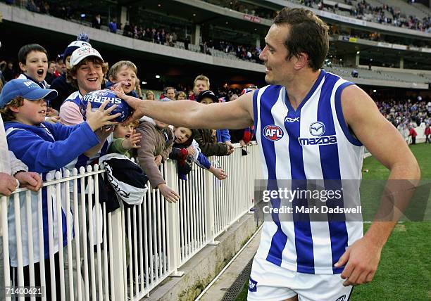 Game player Shannon Watt of the Kangaroos celebrates with fans after winning the round fourteen AFL match between the Western Bulldogs and the...