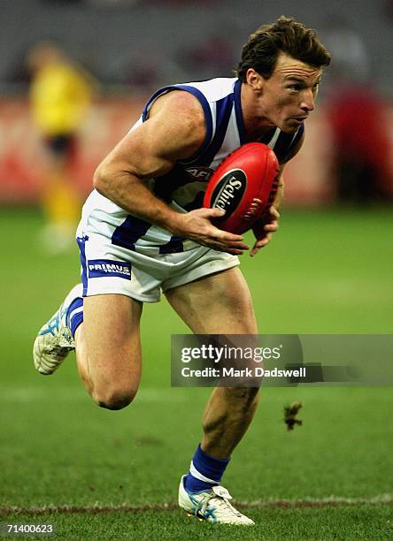 Brent Harvey of the Kangaroos gathers the ball during the round fourteen AFL match between the Western Bulldogs and the Kangaroos at the Melbourne...