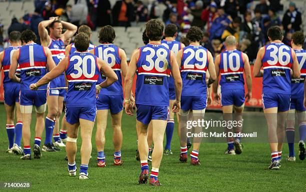 Bulldogs players leave the ground dejected after losing the round 14 AFL match between the Western Bulldogs and the Kangaroos at the Melbourne...