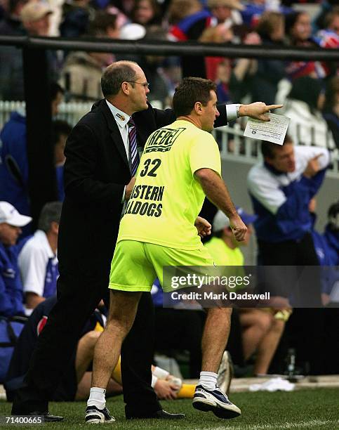 Rodney Eade Coach of the Bulldogs gives instructions to his runner during the round fourteen AFL match between the Western Bulldogs and the Kangaroos...