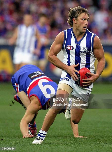 Jess Sinclair of the Kangaroos breaks away from Lindsay Gilbee of the Bulldogs during the round 14 AFL match between the Western Bulldogs and the...