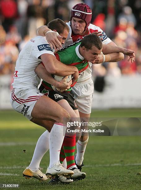 Todd Polglase of the Rabbitohs is wrapped up by the defence during the round 18 NRL match between the St.George Illawarra Dragons and the South...