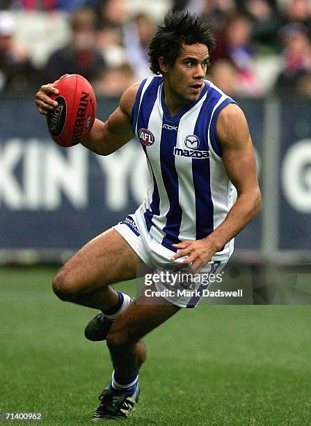 Daniel Wells of the Kangaroos gathers the ball during the round fourteen AFL match between the Western Bulldogs and the Kangaroos at the Melbourne...