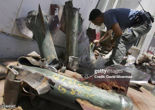 An Israeli policeman dates the Palestinian Qassam rockets that hit this town the previous days where the weekend's tally of rockets is stored at the...