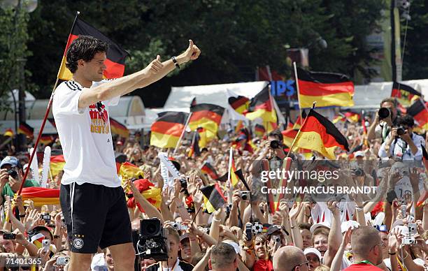German midfielder and captain Michael Ballack waves to supporters from the stage 09 July 2006 at the Fan Fest in Berlin. One million people took over...