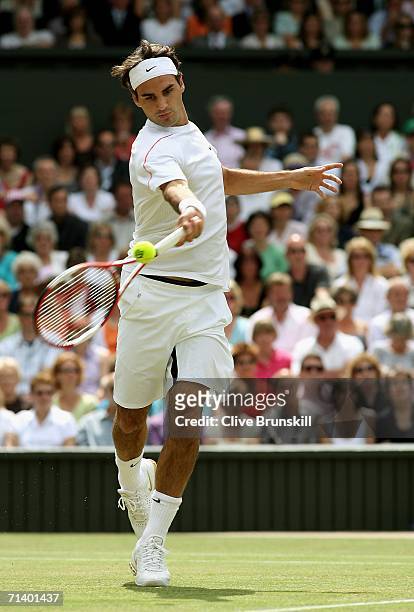 Roger Federer of Switzerland returns a forehand to Rafael Nadal of Spain during the men's final on day thirteen of the Wimbledon Lawn Tennis...