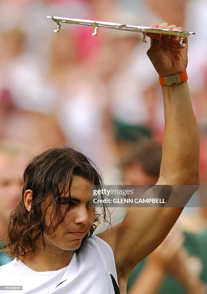 Rafael Nadal of Spain holds his trophy after losing against Roger