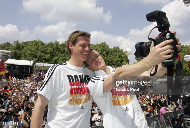 Robert Huth of Germany takes a picture of himself and Tim Borowski of Germany at the fan mile at Brandenburger Tor on July 9, 2006 in Berlin, Germany.