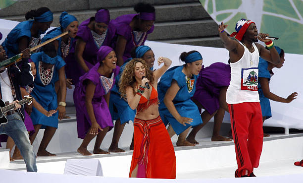Colombian singer Shakira and US hip hop singer Wyclef Jean perform on the stage during a ceremony prior the World Cup final football match between...