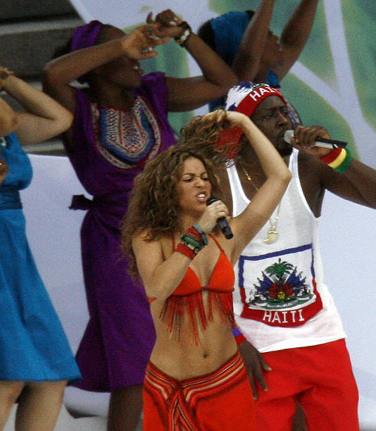 Colombian singer Shakira and US hip hop singer Wyclef Jean perform on the stage during a ceremony prior the World Cup final football match between...
