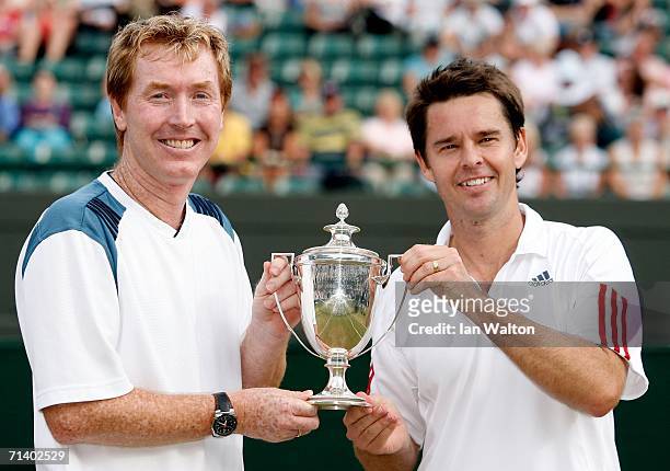 Todd Woodbridge and Mark Woodforde of Australia hold the trophy after winning the Gentlemen's 35 & over doubles against T-J Middleton and David...