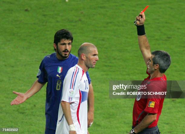 French midfielder Zinedine Zidane receives a red card from referee Horacio Elizondo of Argentina for head-butting Italian defender Marco Materazzi in...