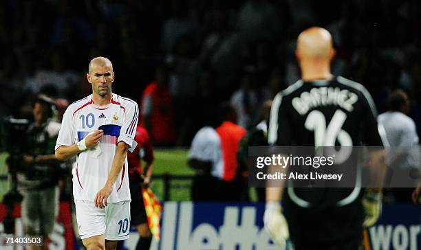 Zinedine Zidane of France removes his captains armband to give to teammate Fabien Barthez after being sent off during the FIFA World Cup Germany 2006...