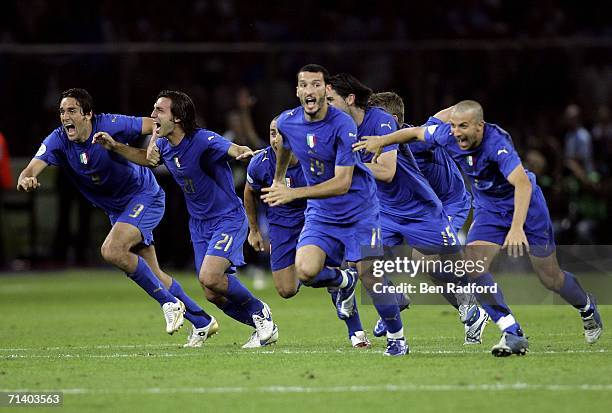 Italian players celebrate after teammate Fabio Grosso, scores the matchwinning penalty during the FIFA World Cup Germany 2006 Final match between...