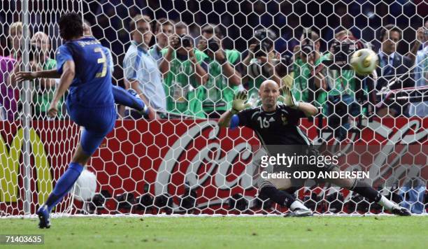 Italian defender Fabio Grosso shoots the winning penalty against French goalkeeper Fabien Barthez during the World Cup 2006 final football game Italy...